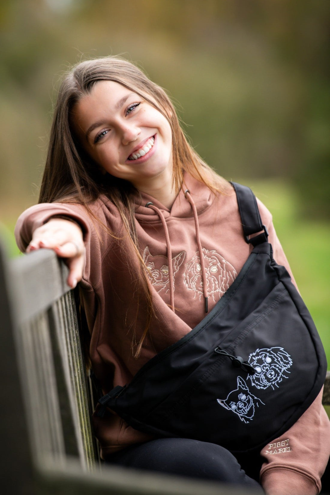 Custom embroidered hoodie and cross body bag with dogs faces embroidered on them