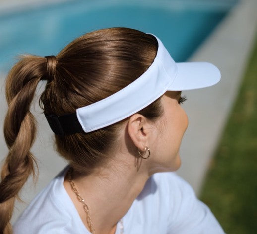 Woman wearing white visor
