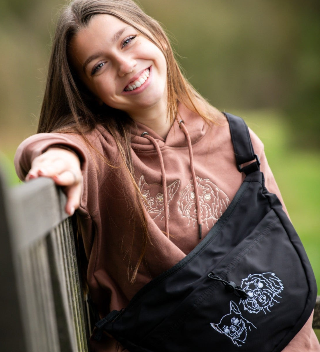 Custom embroidered hoodie and cross body bag with dogs faces embroidered on them