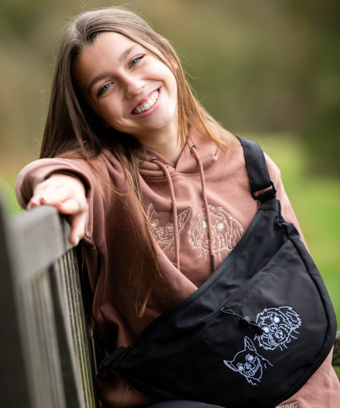 Custom embroidered hoodie and cross body bag with dogs faces embroidered on them