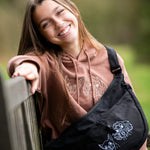 Custom embroidered hoodie and cross body bag with dogs faces embroidered on them