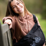 Custom embroidered hoodie and cross body bag with dogs faces embroidered on them